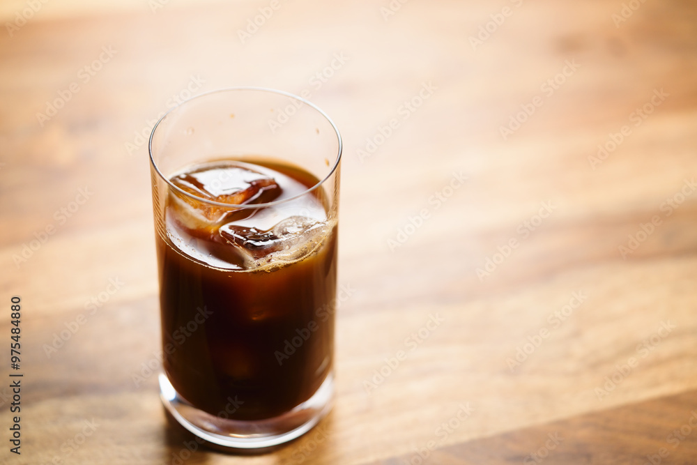 Glass of iced coffee on wooden table Glass of iced coffee on wooden table