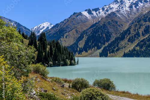 Beautiful mountain lake, forest and mountains. Big Almaty lake in summer time. Mountain landscape in Kazakhstan. photo