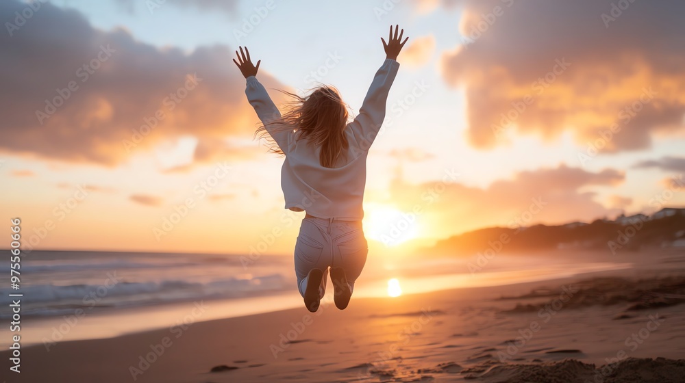 Woman jumping joyfully on a beach at sunset, with outstretched arms, celebrating freedom and nature's beauty. Woman jumping joyfully on a beach at sunset, with outstretched arms, celebrating freedom and nature's beauty.