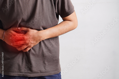 Fitness, stomach ache and man outdoor after running, workout or exercise. Sports, abdominal pain and male athlete in nature with injury, emergency or problem, sick or hernia after training mockup.