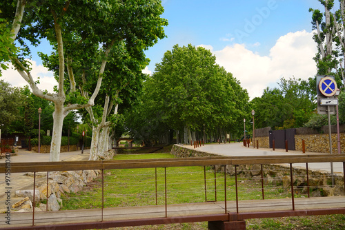 Peratallada, park next to the historic centre with small alleys and medieval Romanesque buildings at at a sunny day with blue sky, Pals, Begur, Girona, Catalonia, Costa Brava, Spain