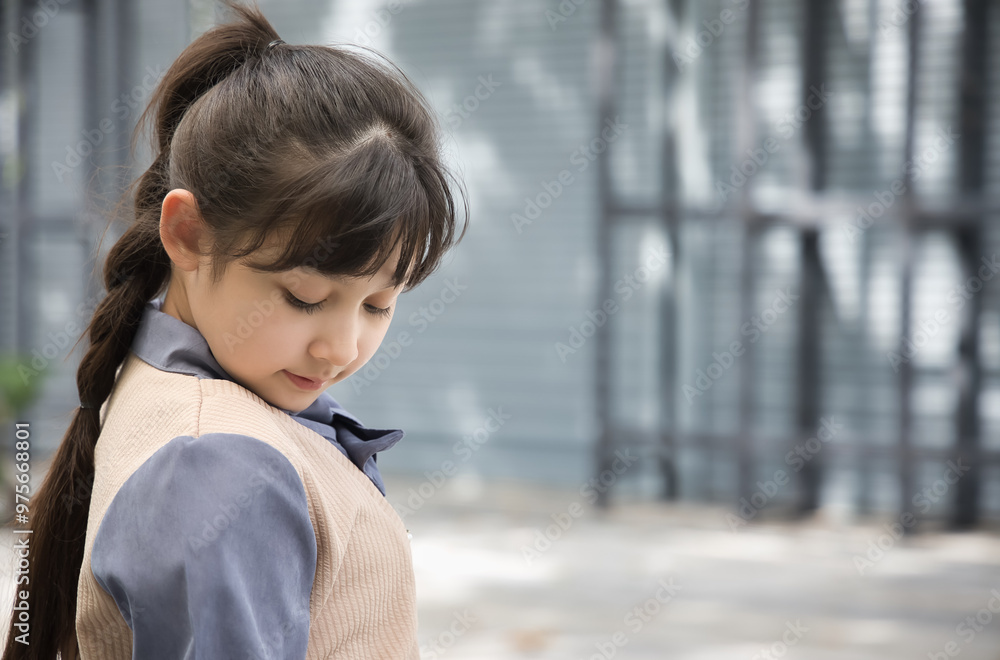 Sad and feeling down asian little primary school girl looking and thinking about something negative Sad and feeling down asian little primary school girl looking and thinking about something negative