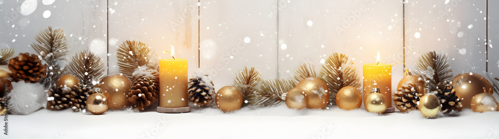 Golden Christmas candles, balls and pine cones in a row with spruce branches covered with snow and snowfall on white wooden board background in winter. Horizontal composition. Golden Christmas candles, balls and pine cones in a row with spruce branches covered with snow and snowfall on white wooden board background in winter. Horizontal composition.