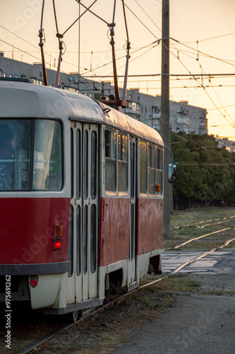 Tram in the city rides into the dawn