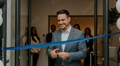 Man cutting a blue ribbon with scissors at a grand opening