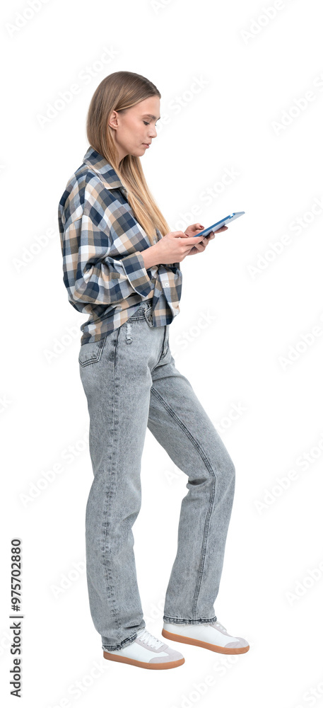 Woman in casual clothes standing and using a smartphone. Isolated on a white background. Concept of communication, technology, and casual lifestyle Woman in casual clothes standing and using a smartphone. Isolated on a white background. Concept of communication, technology, and casual lifestyle