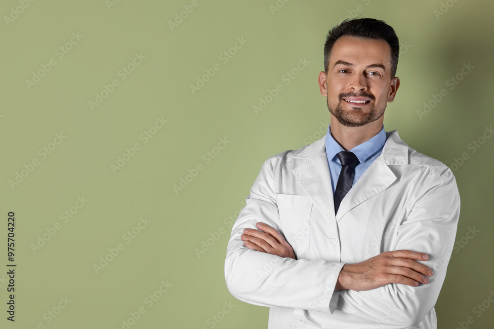 Portrait of smiling doctor on olive background, space for text Portrait of smiling doctor on olive background, space for text