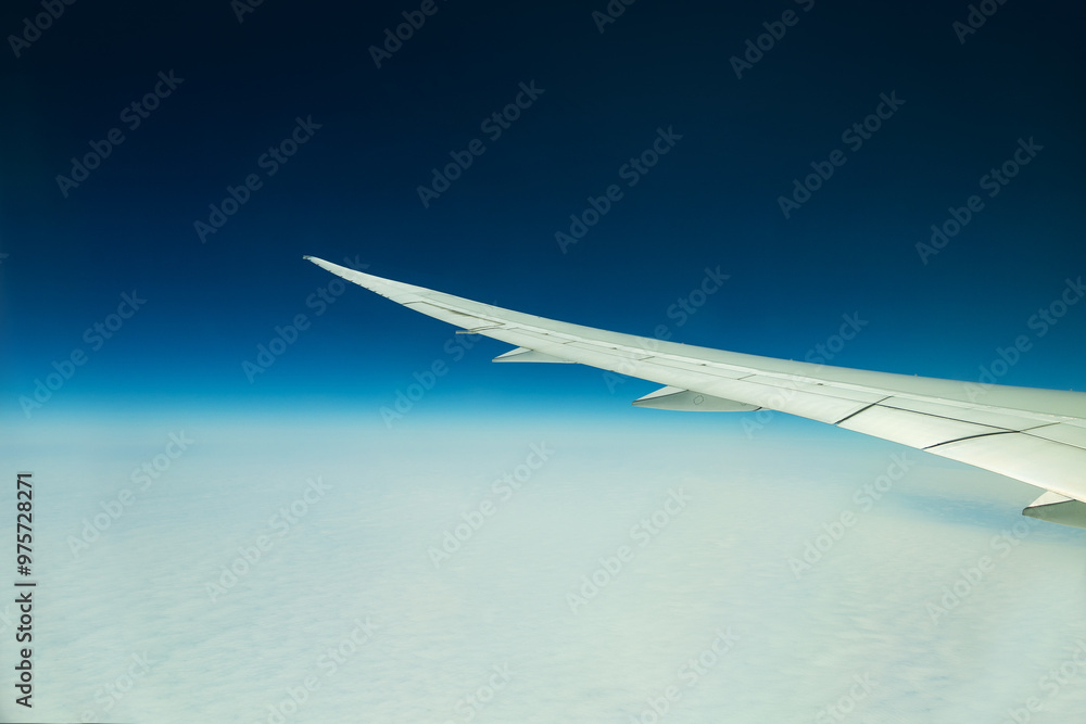 Wing view above the clouds from aircraft window Wing view above the clouds from aircraft window