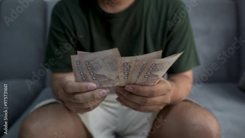Close up of Asian man's hand counting Vietnamese dong currency