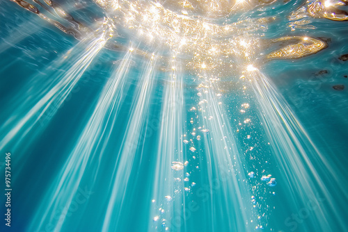 A beautiful blue ocean with sunlight shining through the water. The sunlight creates a sparkling effect, making the water look like it's filled with diamonds. The scene is serene and peaceful photo