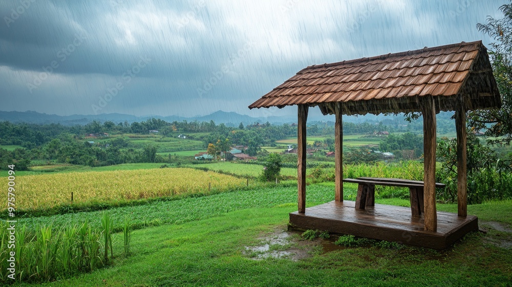 A wooden shelter provides cover from heavy rain, overlooking lush green farmland, highlighting rural life. A wooden shelter provides cover from heavy rain, overlooking lush green farmland, highlighting rural life.