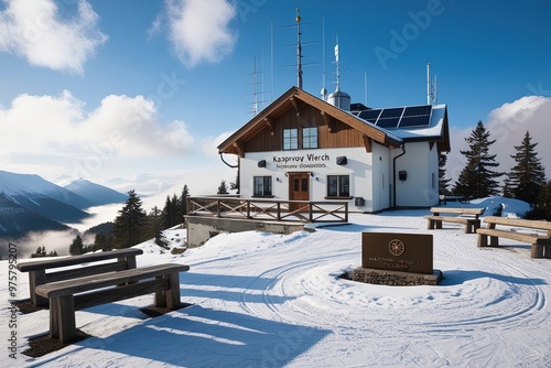 A serene high-mountain Meteorological Observatory situated atop Kasprowy Wierch in the majestic Tatra Mountains of Poland, surrounded by a blanket of snow-covered peaks and pine trees, with wispy fog 