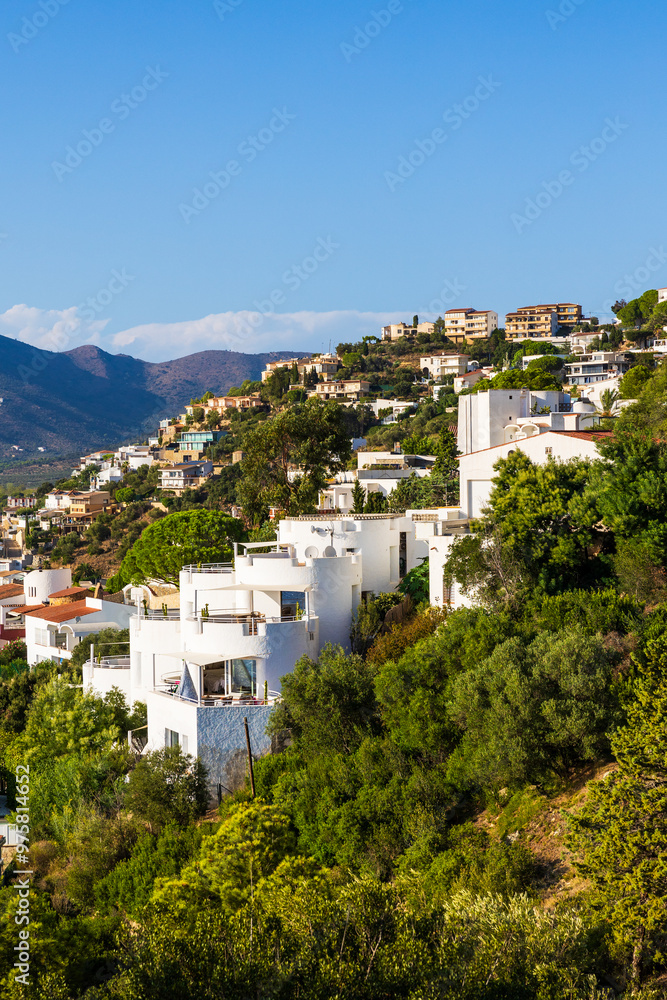 Villas and buildings perched on cliffs in the city of Roses on the Costa Brava, Spain, from the Castell de la Trinitat Villas and buildings perched on cliffs in the city of Roses on the Costa Brava, Spain, from the Castell de la Trinitat