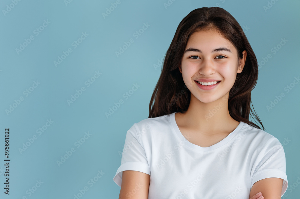Confident Woman in White T-Shirt Smiling Against Blue Background - Professional Portrait Confident Woman in White T-Shirt Smiling Against Blue Background - Professional Portrait