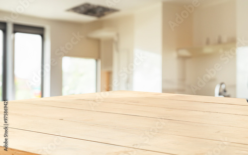 wooden table close up, against wall with warm sunset light from window, table for advertising display your products.