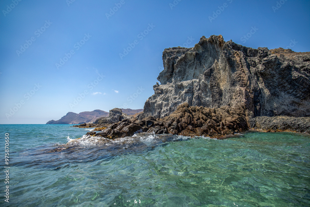 Fototapeta premium Idyllic ando rocky beach of Barronal with blue and transparent waters in the Natural Park of Cabo de Gata and Níjar in Almería, Andalusia, Spain.