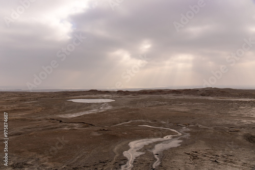 A round boiling lake of a mud volcano near the village of Alyat. Azerbaijan. photo