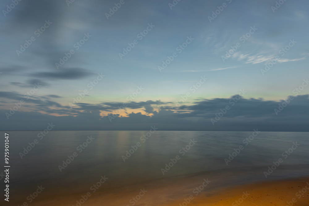 A peaceful seascape at dusk, with soft light illuminating the horizon. Gentle clouds spread across the sky, and the calm ocean reflects the fading colors of the evening. A peaceful seascape at dusk, with soft light illuminating the horizon. Gentle clouds spread across the sky, and the calm ocean reflects the fading colors of the evening.