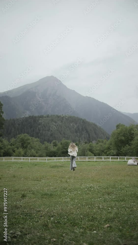 Woman Running in Open Field with Mountain View in the Background Woman Running in Open Field with Mountain View in the Background