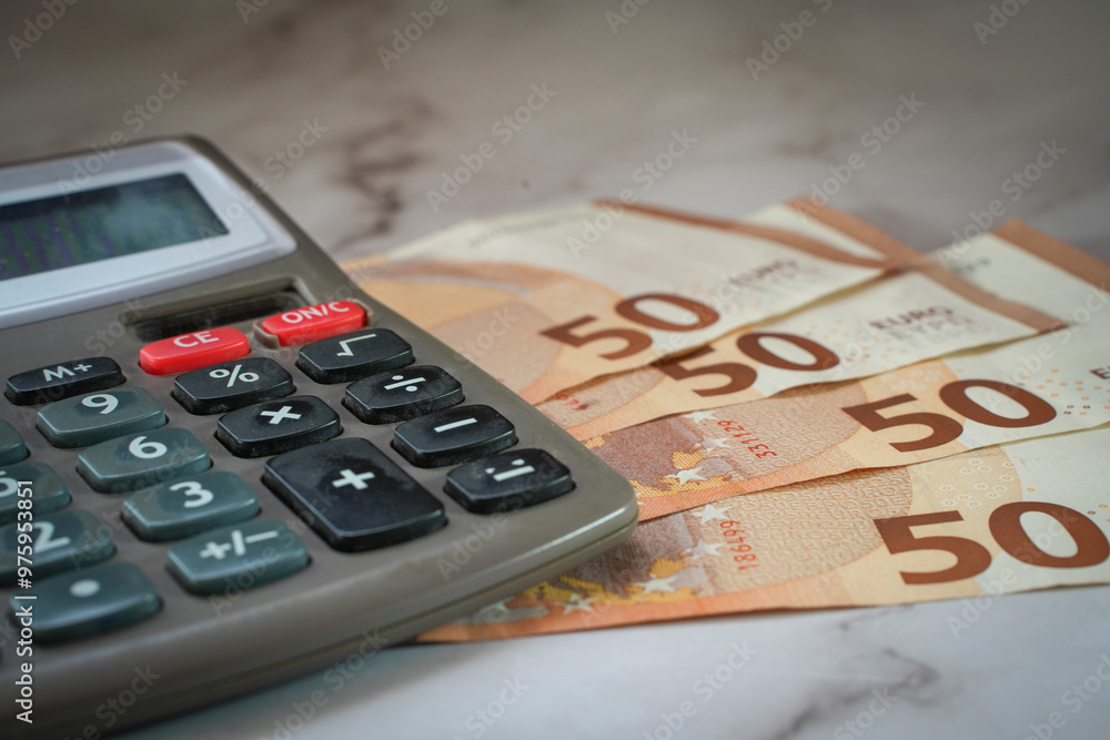 fanned euro bills and calculator with text space fanned euro bills and calculator with text space