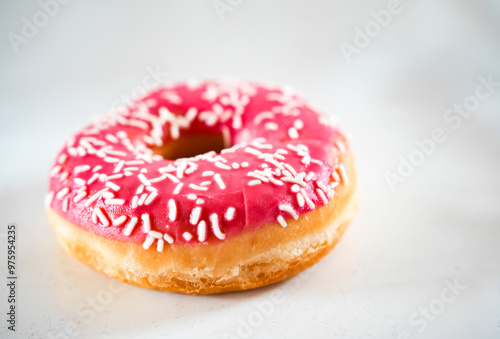 Conceptional bakery stillife of pink donut isolated