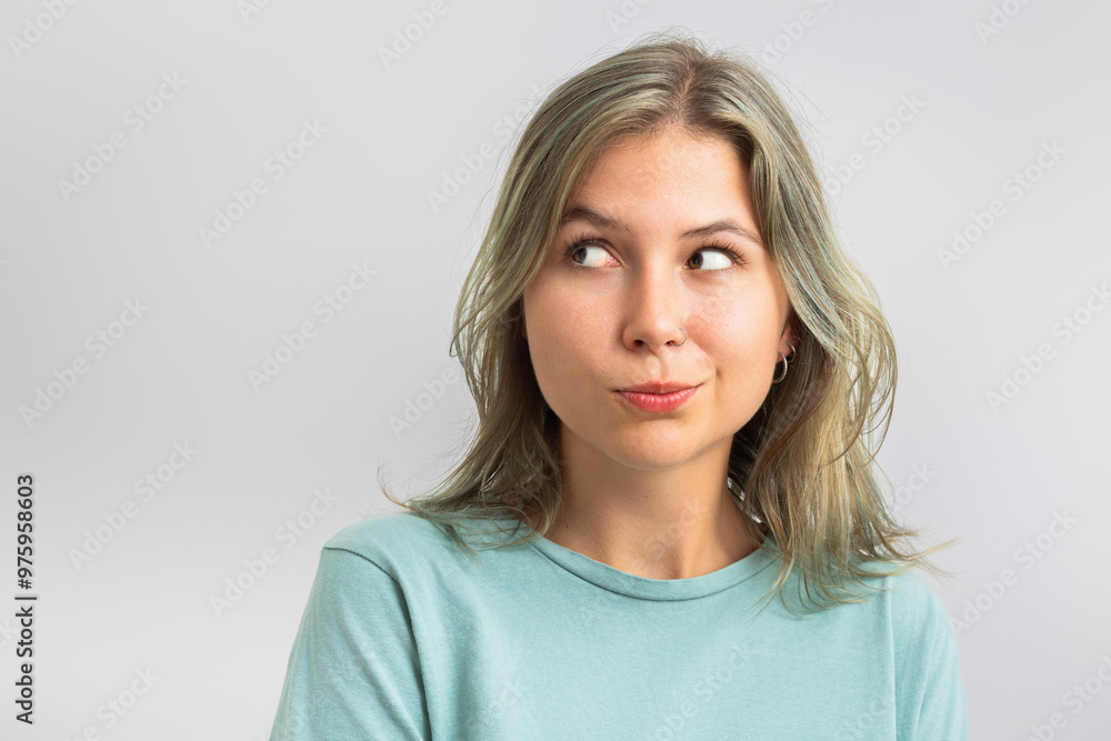 Young woman looking at her side and being interested by something. Young woman looking at her side and being interested by something.