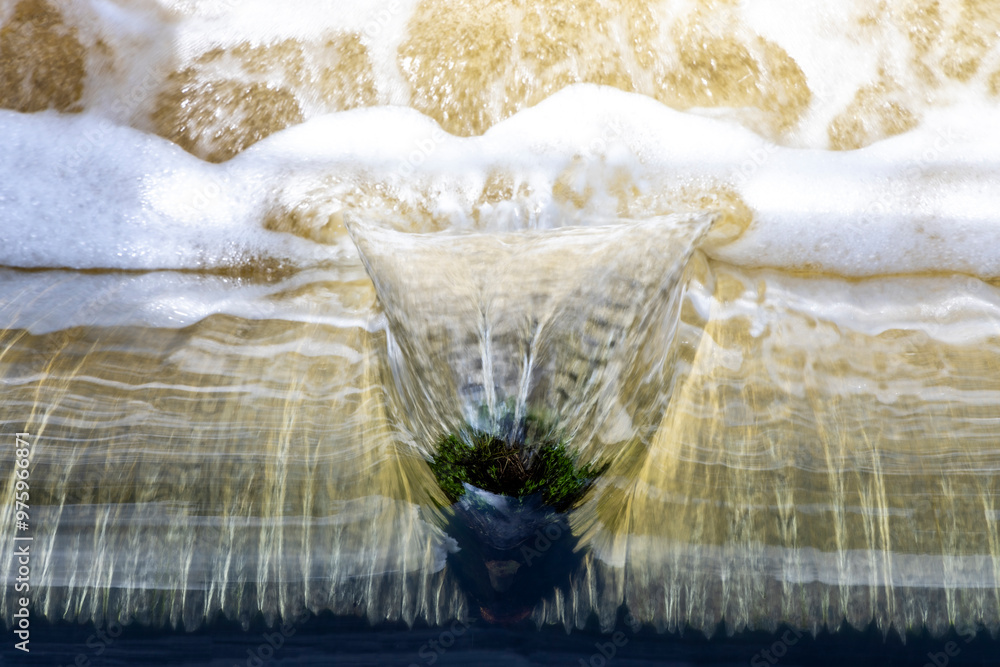 Top view of water flowing over an edge