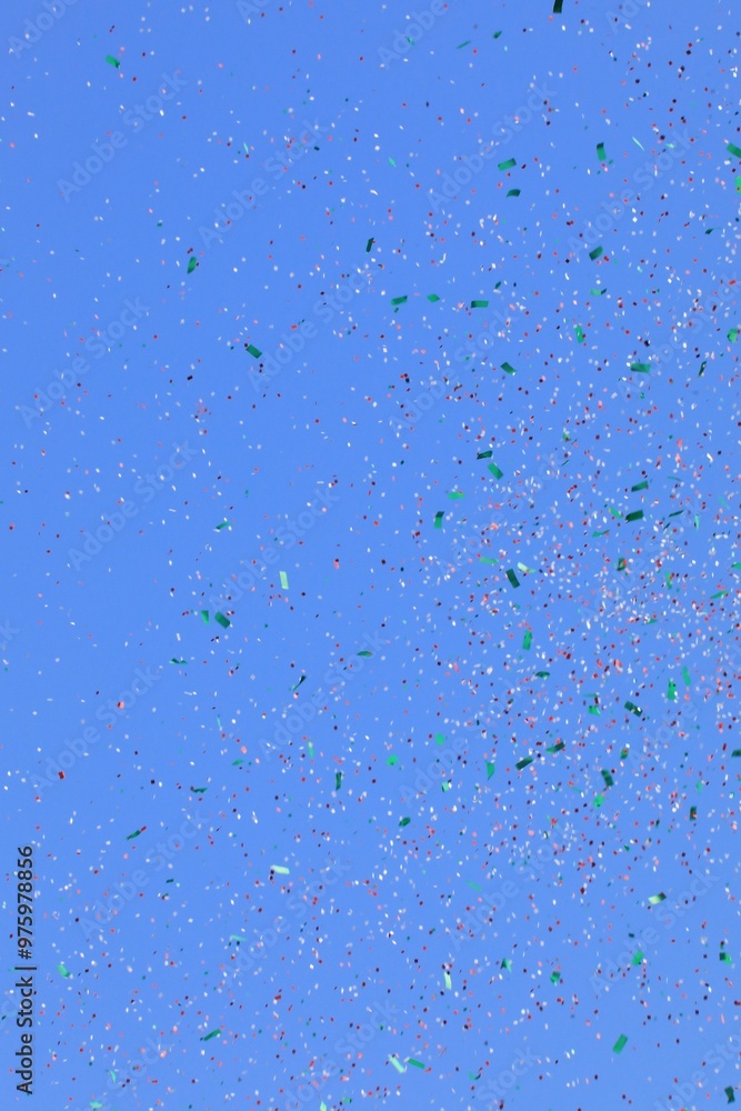 Colorful Confetti against a blue sky Colorful Confetti against a blue sky