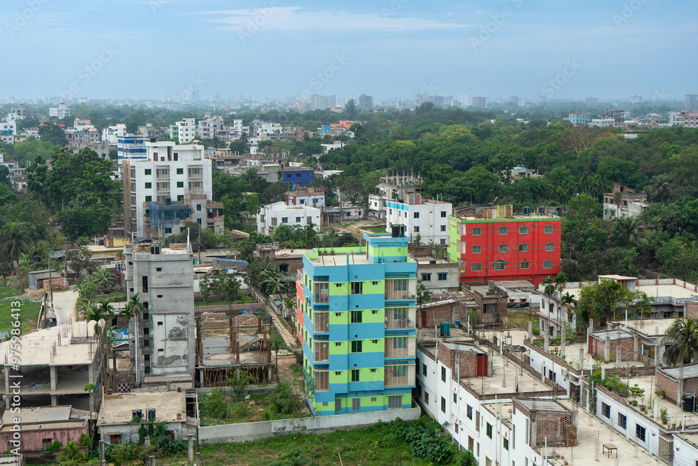 Urban landscape with dense development colorful buildings and lush greenery, showcasing the dense architectural layout of city, Rajshahi, Bangladesh.