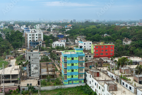 Urban landscape with dense development colorful buildings and lush greenery, showcasing the dense architectural layout of city, Rajshahi, Bangladesh.