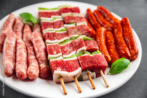 raw sausage meat assorted juicy pork, beef fresh gourmet food background on the table rustick food top view copy space