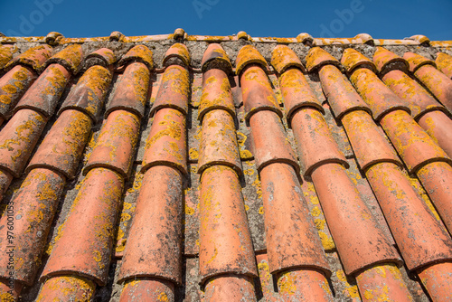 Clay tiles. Close-up of a clay tile roof against a blue sky