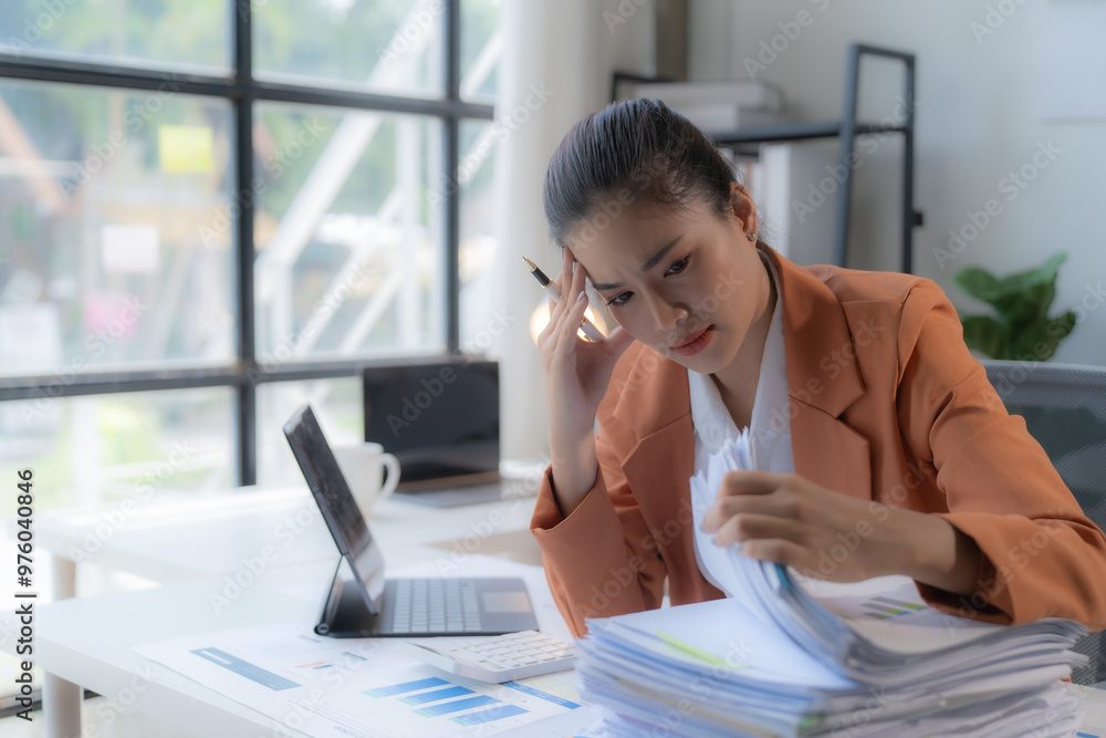 Obraz premium Sad Tired Asian woman Overworked On Computer.Unhappy Frustrated Business Woman, Business Finance Deadline.Sad Tired Businesswoman In Office.Annoyed Overwhelmed Exhausted Stressed