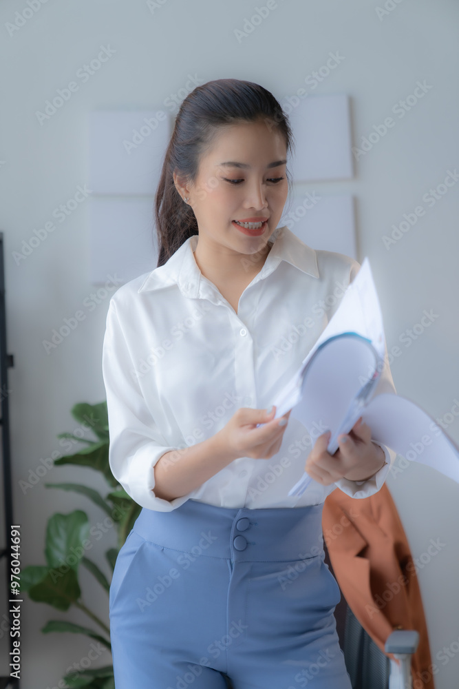 Stressed young manager in modern office taking a break, stretching shoulders, embodying success and professionalism Stressed young manager in modern office taking a break, stretching shoulders, embodying success and professionalism