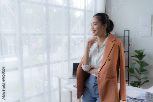 portrait of beautiful young Asian business woman standing while smiling looking at camera in the office Free Download portrait of beautiful young Asian business woman standing while smiling looking at camera in the office - GFXLoad
