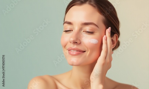 female model washing her face with the cream formula is in focus