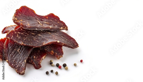 dry savory Peppered Beef Jerky view from above isolated on white background with copy space. lean trimmed meat cut into strips and dehydrated with salt added to prevent spoilage and bacteria growth photo