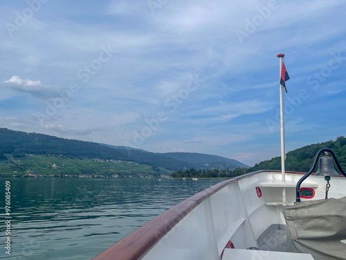 boat on the lake view on Ligerz, Jura mountains, sunny summer day photo