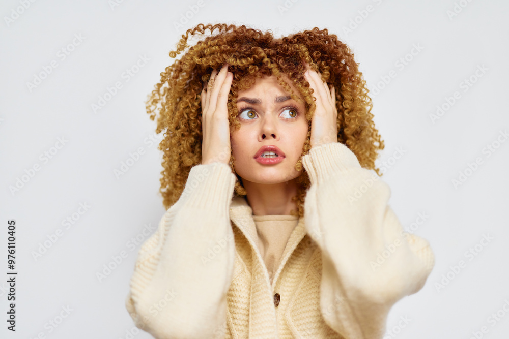 anxious woman with curly hair looking up, wearing a cozy sweater against a light background, expressing concern and contemplation in a close up shot anxious woman with curly hair looking up, wearing a cozy sweater against a light background, expressing concern and contemplation in a close up shot