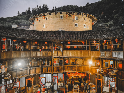 tourists watching view of Huaiyunlou  tulou cluster,is ancient earth dwellings of the Hakka people,located in Yunshuiyao tulou