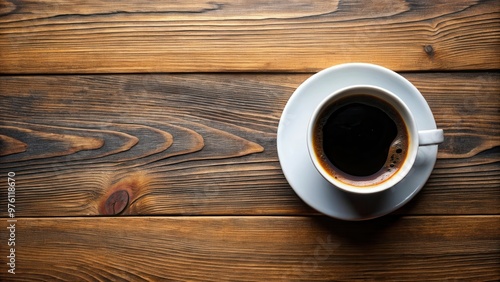 Top view of a cup of black coffee on a wooden table