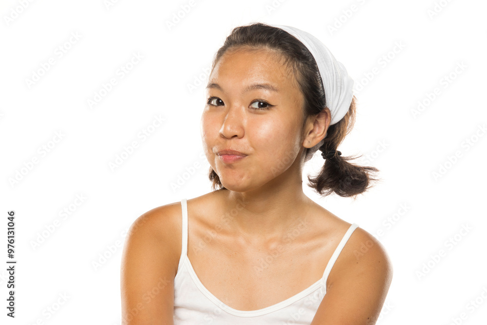 Portrait of a beautiful young smiling Asian woman posing on white studio background Portrait of a beautiful young smiling Asian woman posing on white studio background