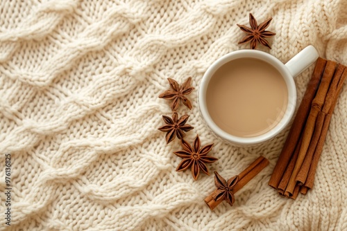 Cozy autumn or winter flat lay coffee cup, cinnamon, anise stars on cream knit blanket