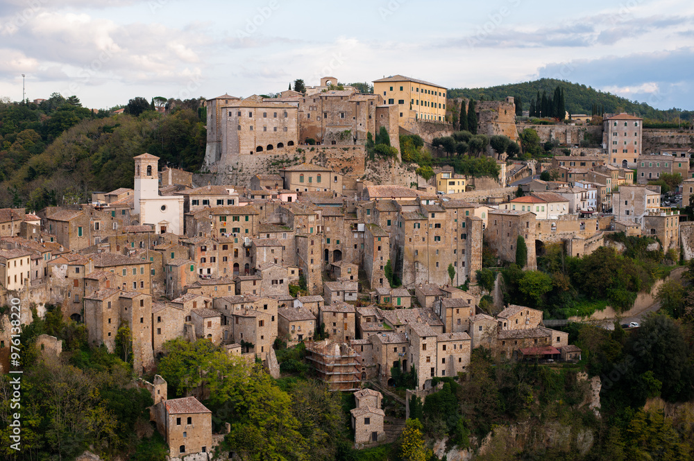 View of Sorano, an ancient medieval hill town composed of tuff stone over the Lente River. Etruscan town. Province Grosseto, Tuscany, Italy. View of Sorano, an ancient medieval hill town composed of tuff stone over the Lente River. Etruscan town. Province Grosseto, Tuscany, Italy.