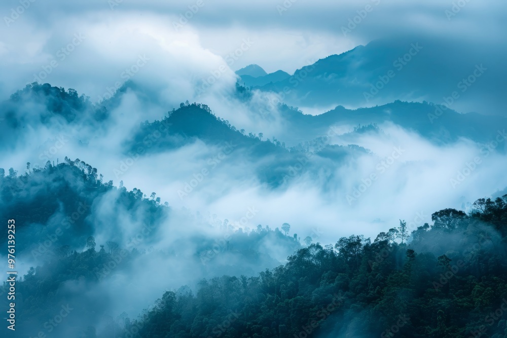 A misty mountain range shrouded in a veil of clouds, creating an air of mystery and tranquility A misty mountain range shrouded in a veil of clouds, creating an air of mystery and tranquility