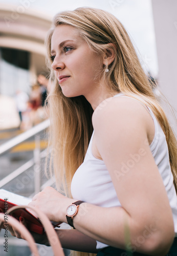 Young pensive woman standing in city with notebook Free Download Young pensive woman standing in city with notebook - GFXLoad