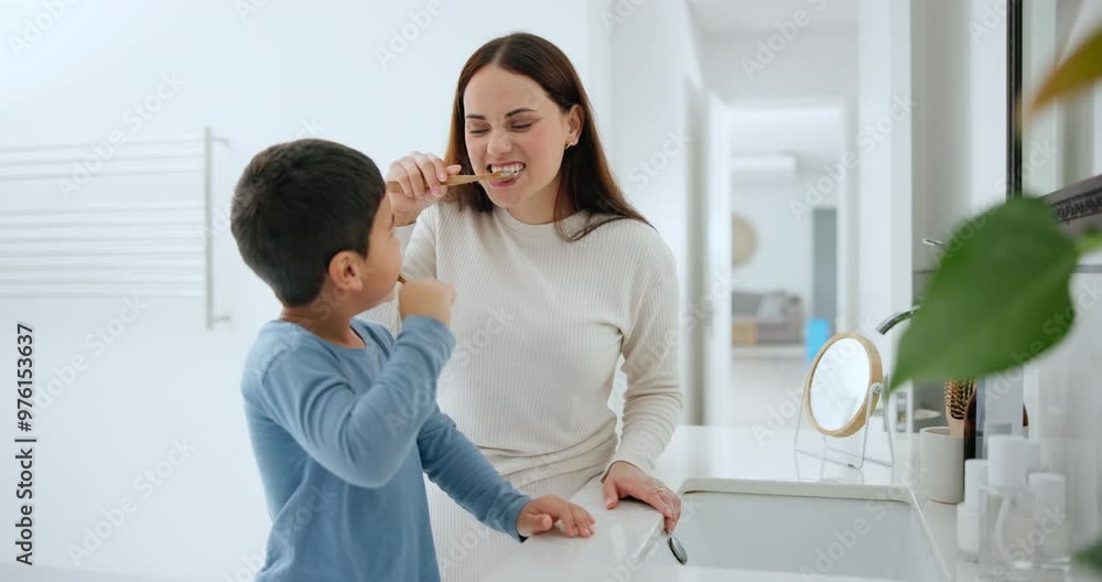 Dental, oral hygiene and a family brushing teeth in the bathroom of their home together for morning routine. Toothbrush, toothpaste or care with a mother and son cleaning their mouth in an apartment Dental, oral hygiene and a family brushing teeth in the bathroom of their home together for morning routine. Toothbrush, toothpaste or care with a mother and son cleaning their mouth in an apartment