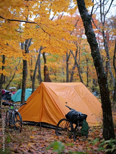 a tent is set up in the woods with a bicycle