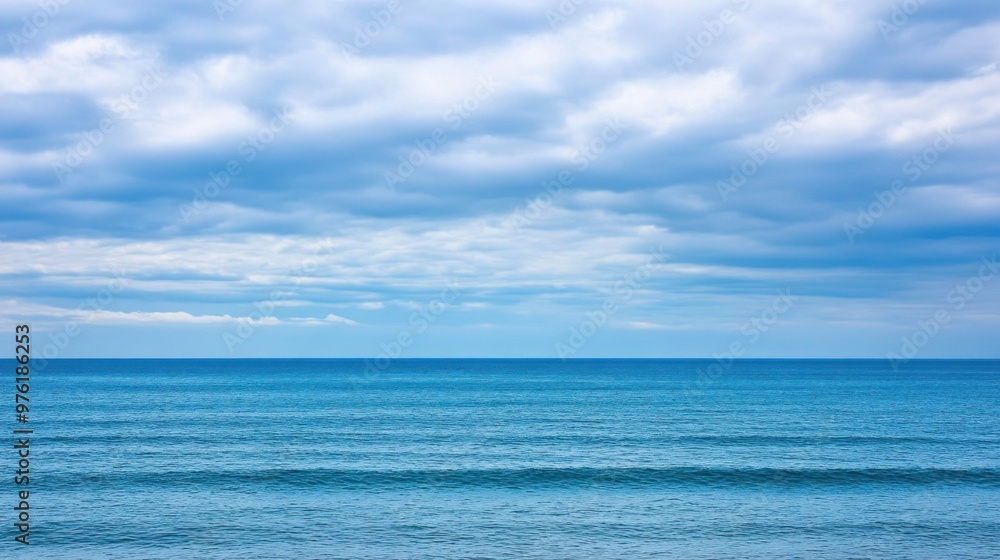 Gentle waves lap against the shore, reflecting the blue tones of the ocean and the cloudy sky, creating a serene coastal atmosphere perfect for relaxation Gentle waves lap against the shore, reflecting the blue tones of the ocean and the cloudy sky, creating a serene coastal atmosphere perfect for relaxation