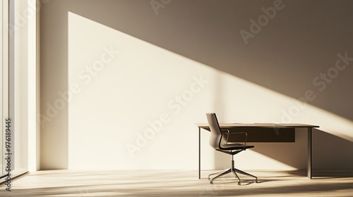 A minimalistic office setting with a single desk and chair, illuminated by natural light, against a light solid color wall